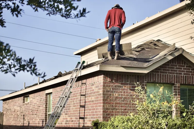 Professional roofer working on a residential roof in North Riverside